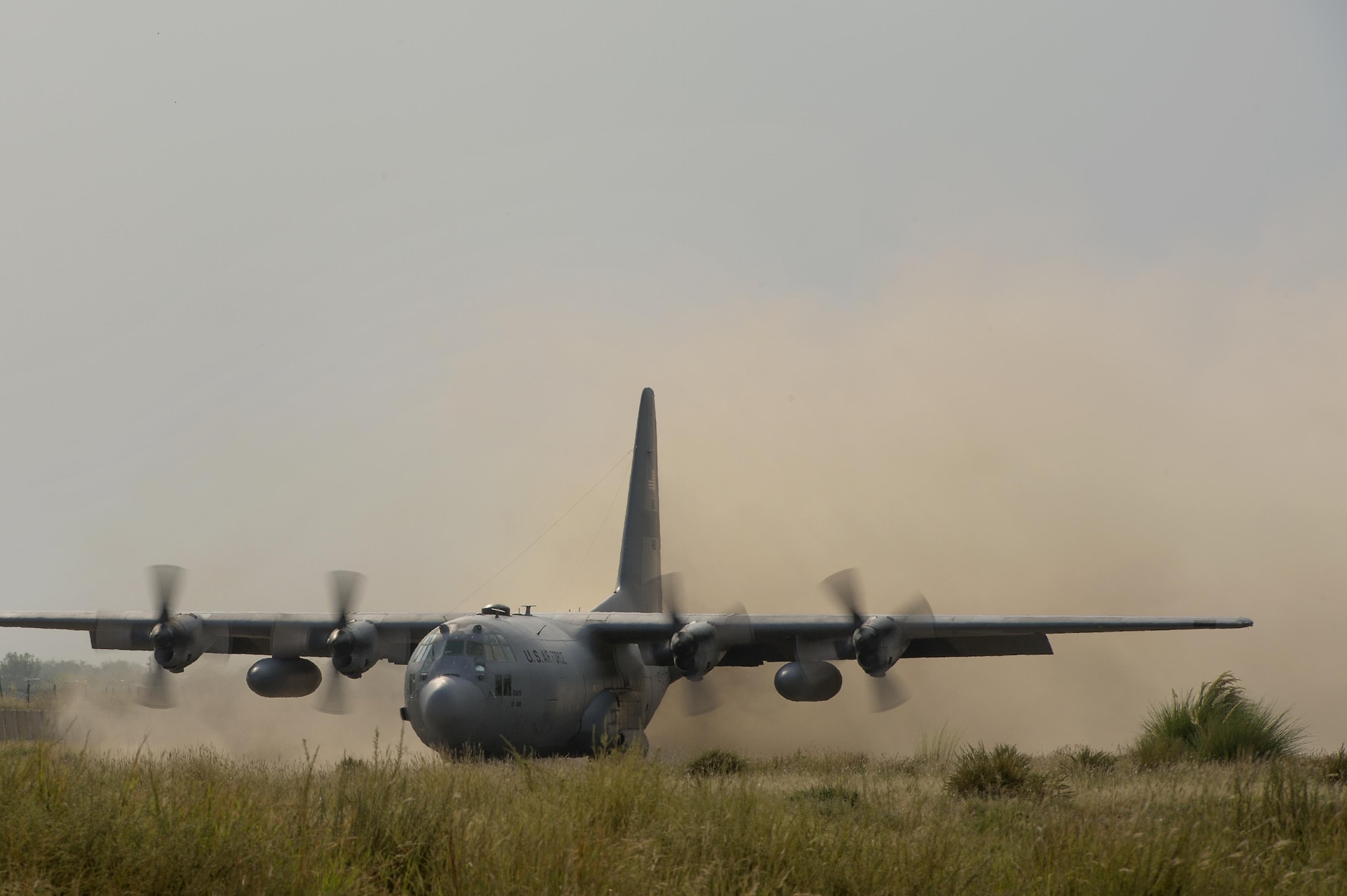A 774th Expeditionary Airlift Squadron C-130 Hercules cargo plane kicks up dirt on a short runway landing at Forward Operating Base Salerno, Khost province, Afghanistan, Sept. 21, 2013. The 19th Movement Control Team, a small squadron of Air Force surface movement controllers and aerial porters, have the herculean task of overseeing the vast majority of retrograde operations at FOB Salerno. (USAF Photo/Master Sgt. Ben Bloker)