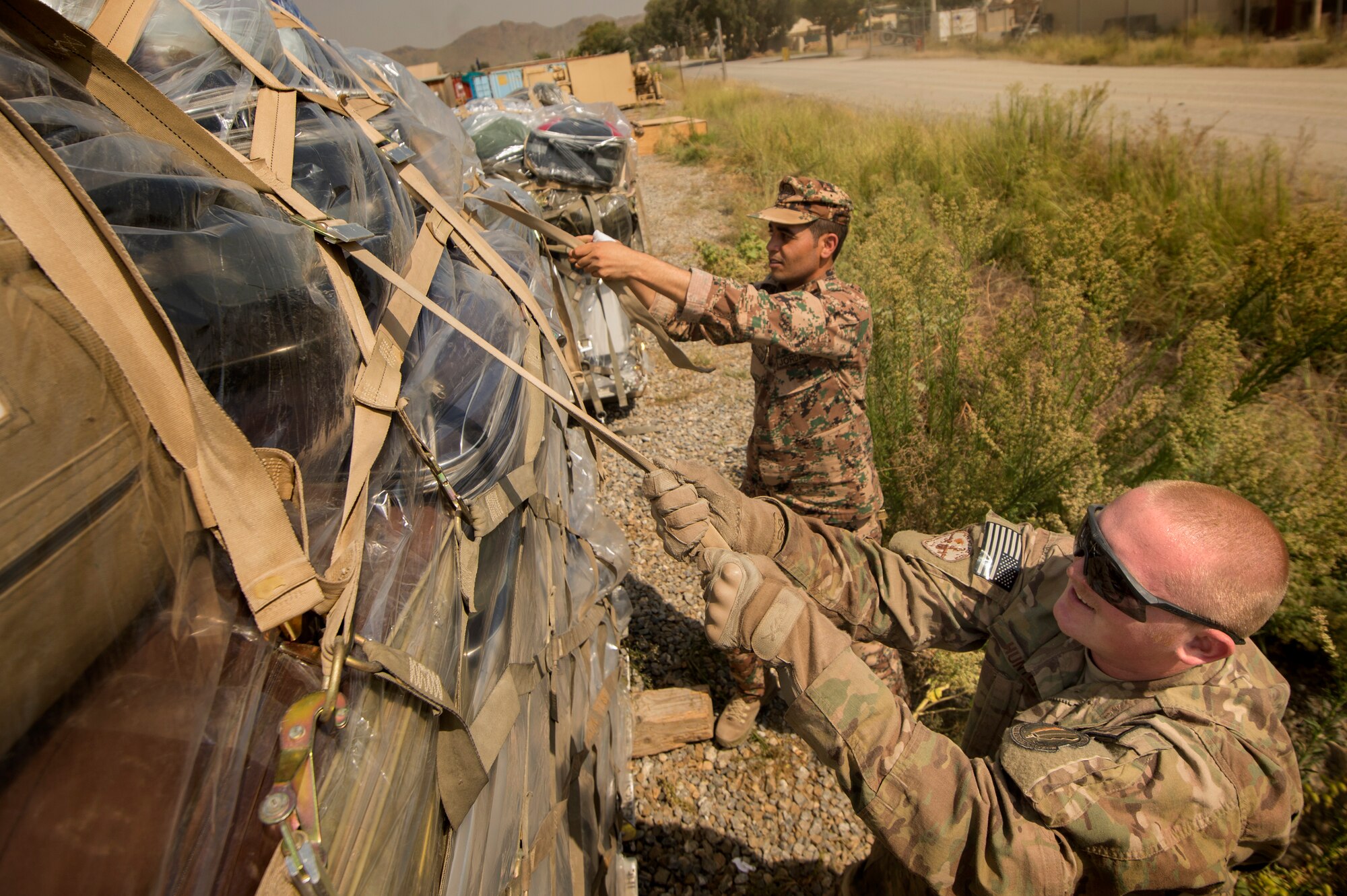 Senior Airman Matthew Hunter, 19th Movement Control Team aerial porter, helps Sgt. Bandar Al Saleem of the Jordanian Army palletize their luggage at Forward Operating Base Salerno, Khost Province, Afghanistan, Sept. 22, 2013. The 19th MCT, a small squadron of Air Force surface movement controllers and aerial porters, have the herculean task of overseeing the vast majority of retrograde operations at FOB Salerno. Hunter, a native of Trophy Club, Texas is forward deployed from Travis Air Force Base, Calif. (USAF Photo/Master Sgt. Ben Bloker)