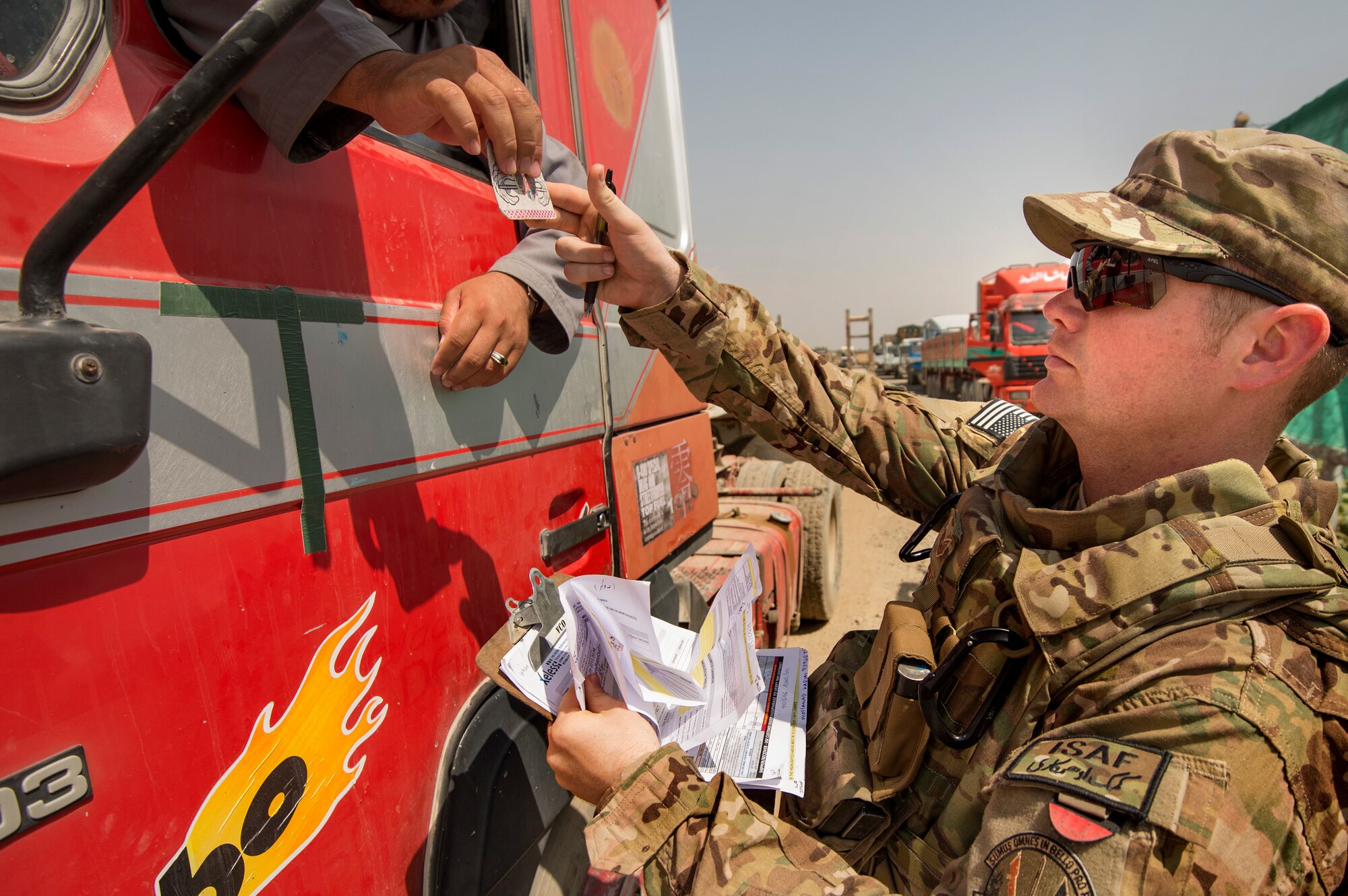 Staff Sgt. Brendan Victory, 19th Movement Control Team surface movement Airman, checks an Afghan truck driver’s credentials at Forward Operating Base Salerno, Khost Province, Afghanistan, Sept. 22, 2013. The 19th MCT, a small squadron of Air Force surface movement controllers and aerial porters, have the herculean task of overseeing the vast majority of retrograde operations at FOB Salerno. Victory, a Mt. Laurle, N.J. native, is deployed from RAF Lakenheath, England. (USAF Photo/Master Sgt. Ben Bloker)