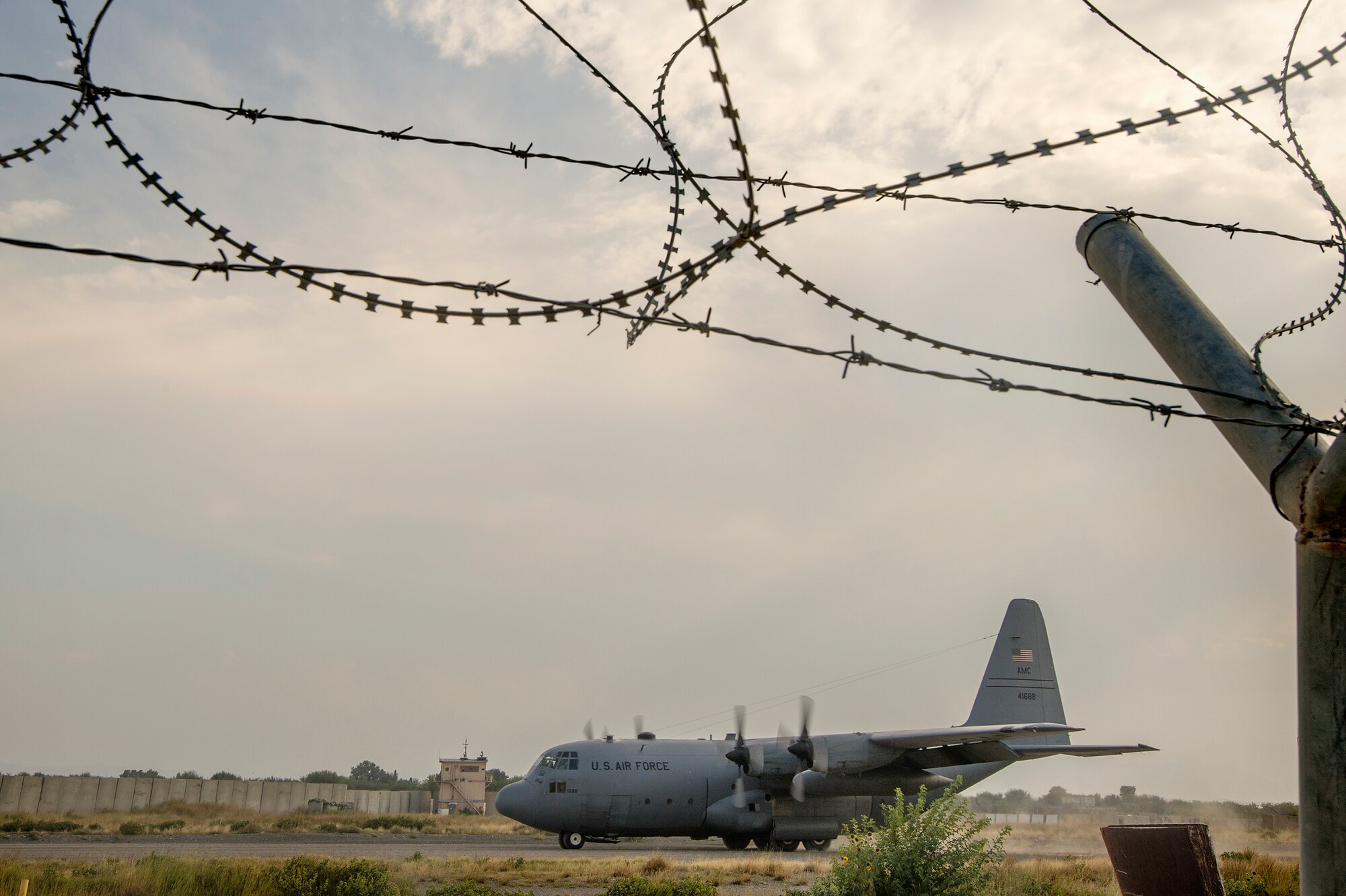 A 774th Expeditionary Airlift Squadron C-130 Hercules cargo plane kicks up dirt on a short runway landing at Forward Operating Base Salerno, Khost province, Afghanistan, Sept. 21, 2013. The 19th Movement Control Team, a small squadron of Air Force surface movement controllers and aerial porters, have the herculean task of overseeing the vast majority of retrograde operations at FOB Salerno. (USAF Photo/Master Sgt. Ben Bloker)