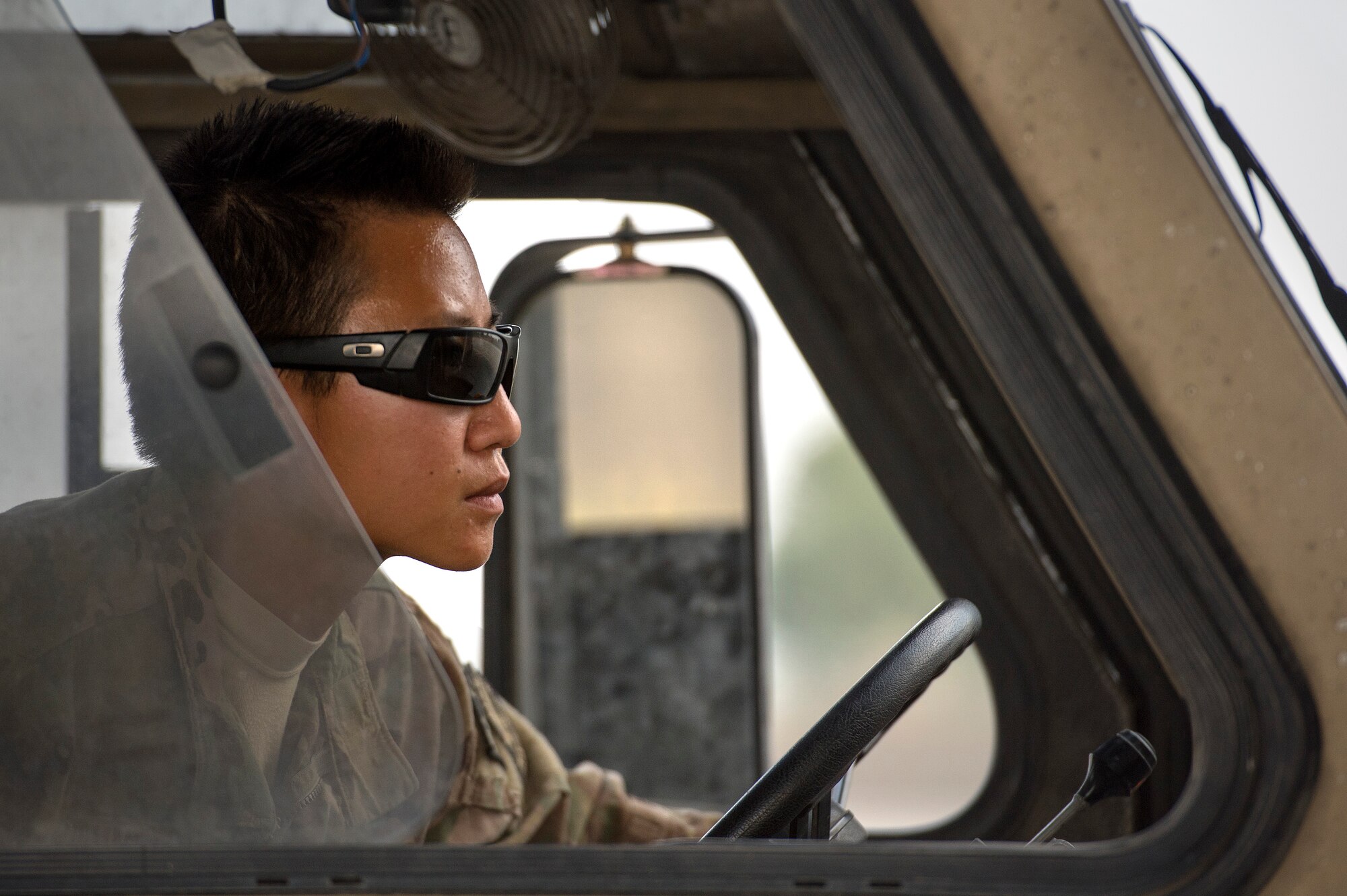 Senior Airman Leah Johnson, 19th Movement Control Team aerial porter, manipulates a K-loader into position to transfer pallets to a C-130 Hercules cargo plane at Forward Operating Base Salerno, Khost province, Afghanistan, Sept. 22, 2013. The 19th MCT, a small squadron of Air Force surface movement controllers and aerial porters, have the herculean task of overseeing the vast majority of retrograde operations at FOB Salerno. Johnson, a St. Paul, Minn. native, is deployed from Travis Air Force Base, Calif. (USAF Photo/Master Sgt. Ben Bloker)




