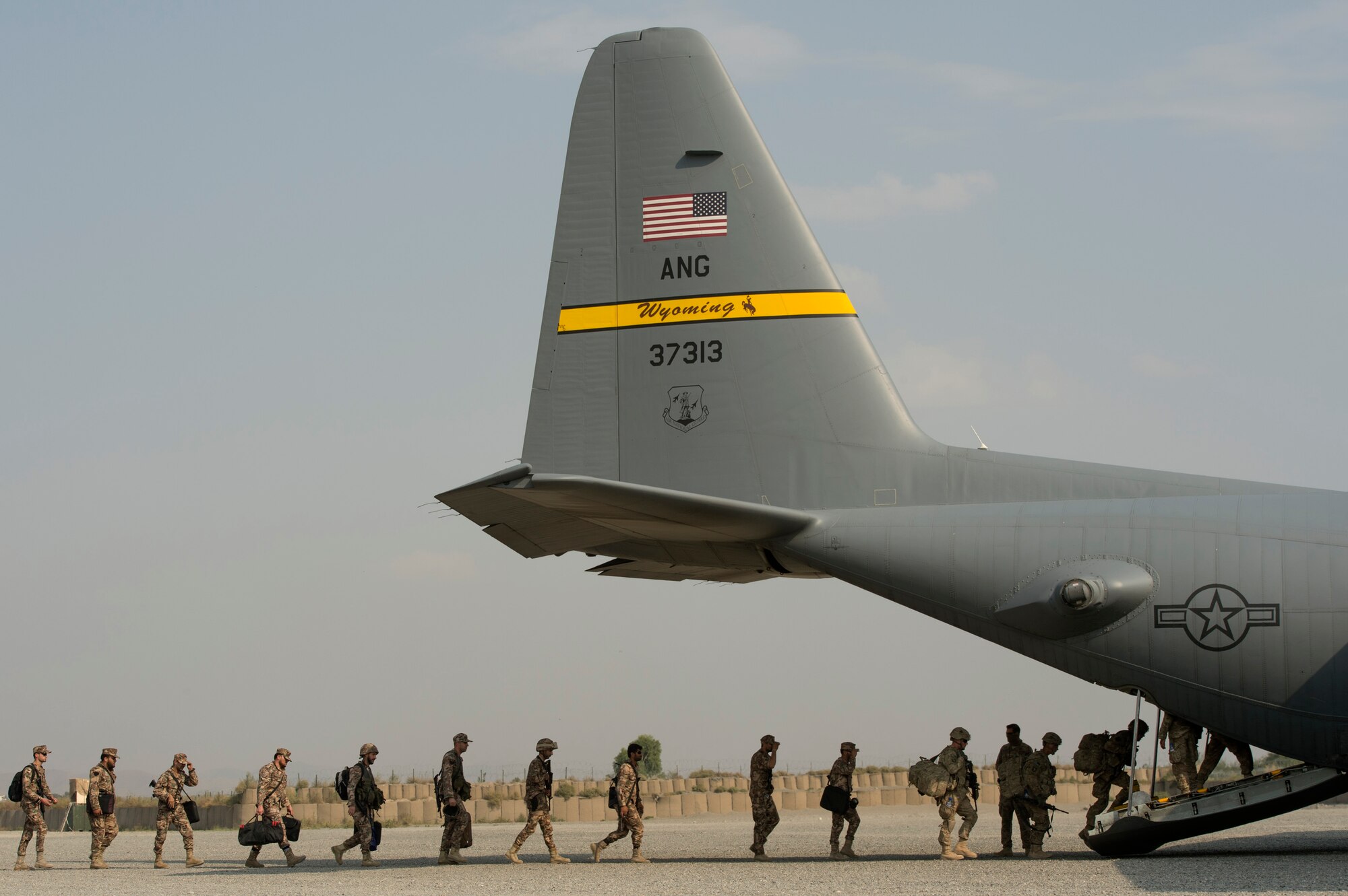 U.S. Army 101st Airborne Division and Jordanian soldiers make their way to a 774th Expeditionary Airlift Squadron C-130 Hercules cargo plane at Forward Operating Base Salerno, Khost province, Afghanistan, Sept. 23, 2013. The 19th Movement Control Team, a small squadron of Air Force surface movement controllers and aerial porters, have the herculean task of overseeing the vast majority of retrograde operations at FOB Salerno. (USAF Photo/Master Sgt. Ben Bloker)

