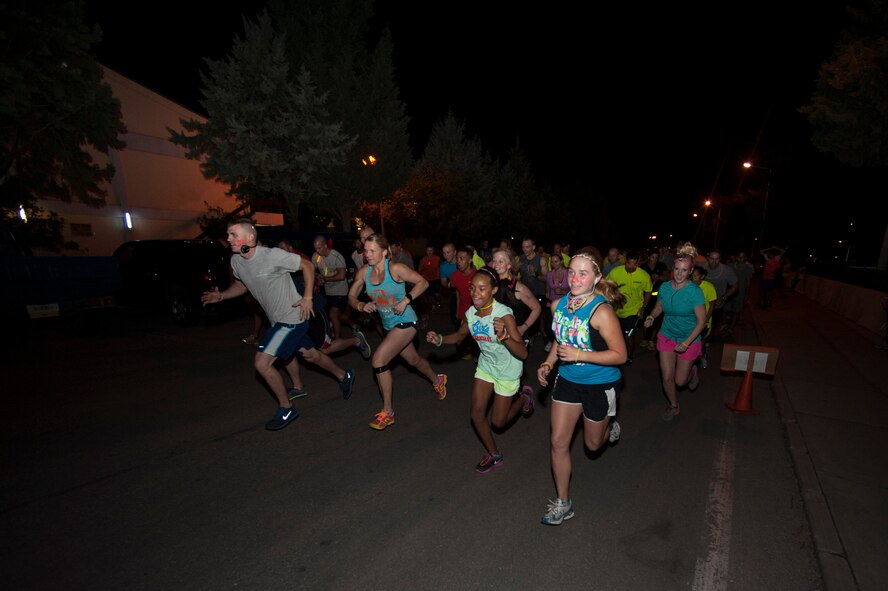 Runners start the Combined Federal Campaign Overseas glow run Sept. 28, 2013, at Incirlik Air Base, Turkey.  More than 100 participants showed their CFC-O support by dressing themselves and their children in brightly colored clothing and neon paint. (U.S. Air Force photo by Airman 1st Class Nicole Sikorski/Released) 