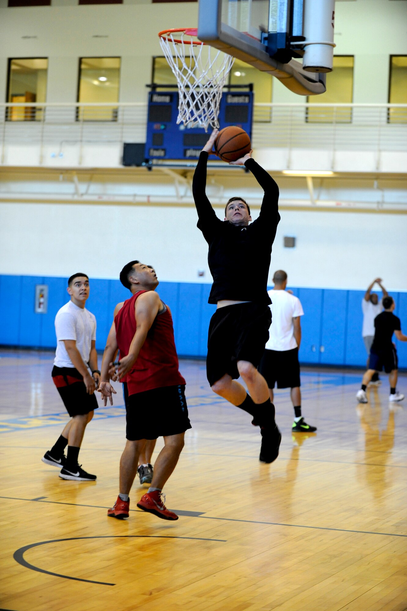 A Wolf Pack Airman shoots a lay-up during a basketball tournament held on Korean and American Friendship Day at Kunsan Air Base, Republic of Korea, Sept. 27, 2013. Basketball was just one activity held during this day dedicated to improving camaraderie and relations with our allied partners in the ROK. (U.S. Air Force photo by Staff Sgt. Jessica Haas/Released)