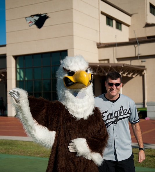 Col. S. Clinton Hinote, 8th Fighter Wing commander, poses with the American Forces Network Eagle in front of the Fitness Center at Kunsan Air Base, Republic of Korea, Sept. 27, 2013. Kunsan celebrated Korean and American Friendship day with several events recognizing the partnership between the U.S. and ROK air force. (U.S. Air Force photo by Senior Airman Clayton Lenhardt/Released)