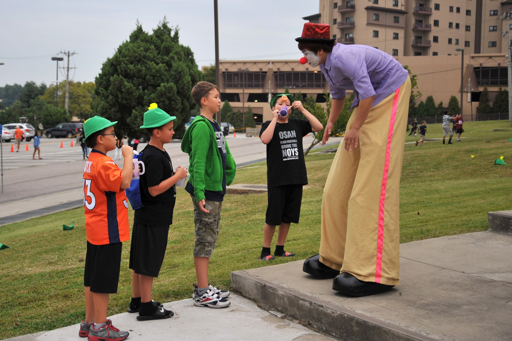 A stilt walker entertains Osan children during Oktoberfest at Osan Air Base, Republic of Korea, Sept. 28, 2013. The four-hour event featured a multitude of entertainment provided by the 51st Force Support Squadron. (U.S. Air Force photo/Staff Sgt. Emerson Nuñez)