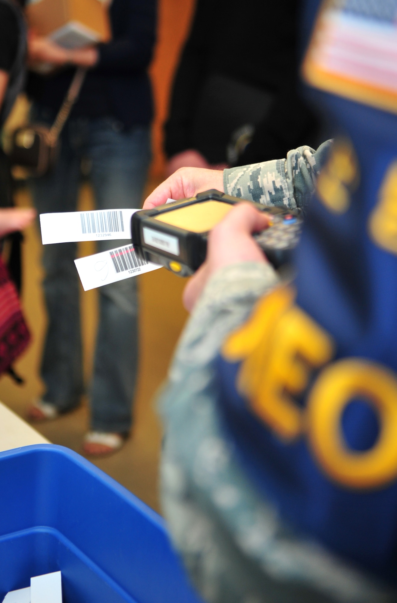 Tech. Sgt. Scott Brown, 7th Air Force personnel readiness NCO in charge, scans identification bracelets as part of a noncombatant evacuation operations exercise at Osan Air Base, Republic of Korea, Sept. 27, 2013. The process is designed to update the NEO Travel System with proof that participants have completed each phase of the NEO process and are ready to board the designated mode of emergency transportation. (U.S. Air Force photo/Airman 1st Class Ashley J. Thum)
