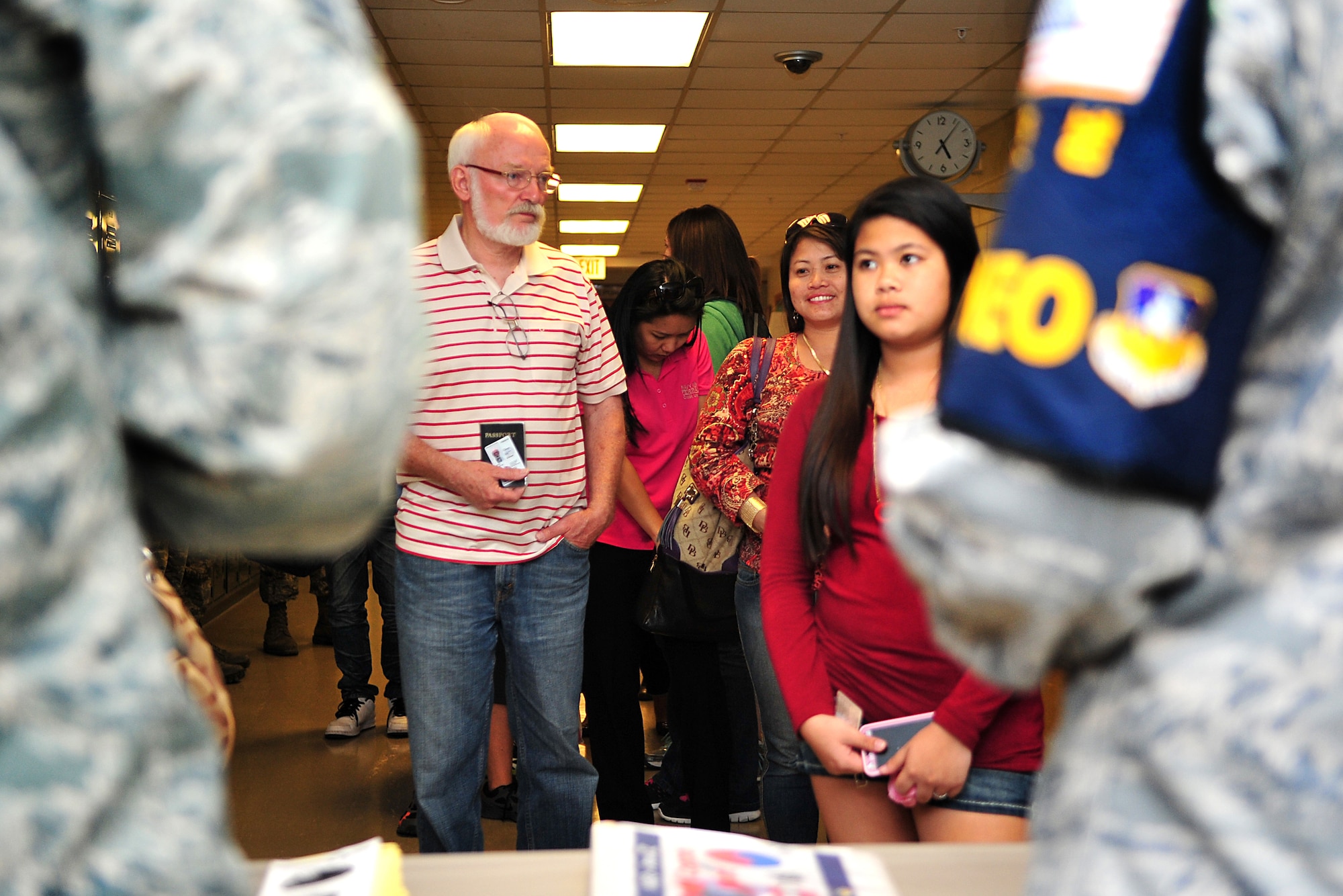 Dependents and other noncombatants line up at an entry control point during a noncombatant evacuation operations exercise at Osan Air Base, Republic of Korea, Sept. 27, 2013. The five-day exercise allowed noncombatants, such as dependents and contractors, to rehearse their evacuation from the Korean peninsula in the event of an emergency. The ECP was manned by various Airmen tasked with checking the identification cards and passports of NEO exercise attendees. (U.S. Air Force photo/Airman 1st Class Ashley J. Thum)