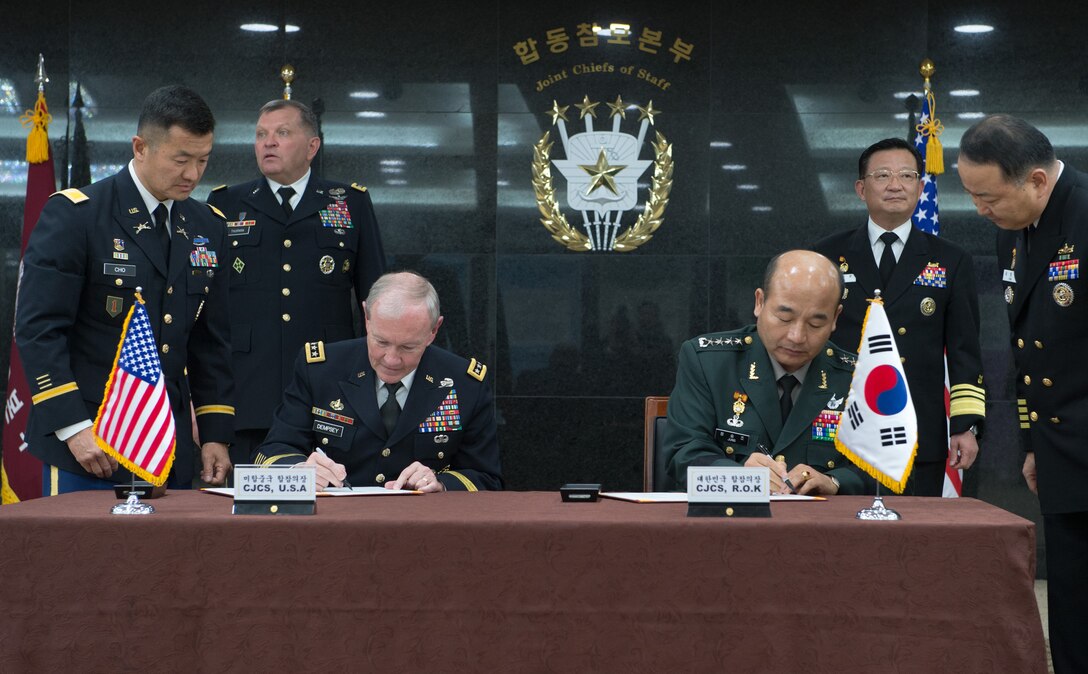 U.S. Army Gen. Martin E. Dempsey, chairman of the Joint Chiefs of Staff, and South Korean Gen. Jung Seung-jo, chairman of the South Korean Joint Chiefs of Staff, sign updated security agreements after a 38th Military Committee meeting in Seoul, South Korea, Sept. 30, 2013. 