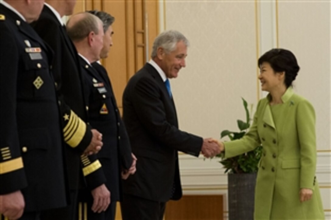 U.S. Defense Secretary Chuck Hagel, center, greets South Korean President Park Geun-hye at the Blue House in Seoul, South Korea, Sept. 30, 2013. The two leaders later met to discuss bilateral defense topics. 
