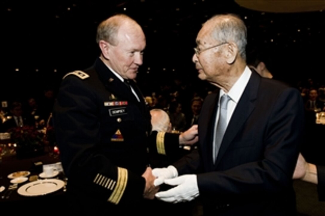 U.S. Army Gen. Martin E. Dempsey, left, chairman of the Joint Chiefs of Staff, speaks with South Korean retired Gen. Paik Sun-yup, a South Korean war hero, during a banquet celebrating the 60th anniversary of the U.S.-South Korean alliance in Seoul, South Korea, Sept. 30, 2013. 