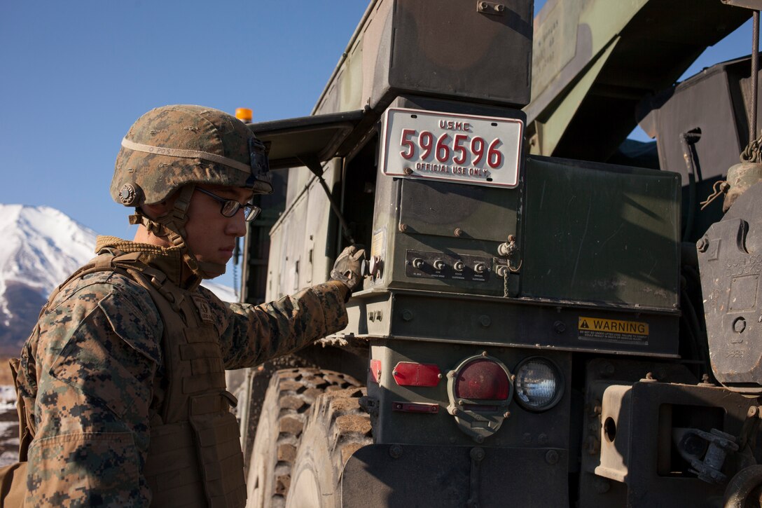 Lance Cpl. Dennon L. Audette controls the towing winch of an MK36 wrecker 7-ton truck at the North Fuji Maneuver Area, Combined Arms Training Center Camp Fuji, January 29 during Artillery Relocation Training Program 13-4. During ARTP 13-4, Marines with 3rd Battalion, 12th Marine Regiment, relied on Motor Transport Maintenance Section to keep more than 100 vehicles operational. Audette is a motor transportation wrecker operator with Headquarters Battery, 3rd Bn., 12th Marines, 3rd Marine Division, III Marine Expeditionary Force. 