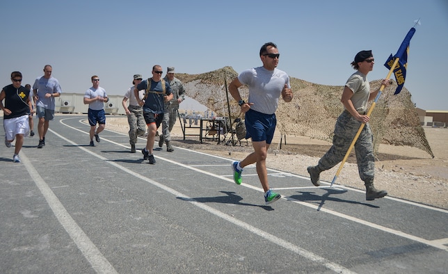 Service members kick off a 24-hour Tactical Air Control Party remembrance run at Al Udeid Air Base, Qatar, March 27, 2014. The event was held to ensure those warriors who have made the ultimate sacrifice are never forgotten. This year’s 24-hour TACP challenge was the third annual event dedicated to the 10 fallen TACP warriors who were killed in combat and training operations within the last 20 years. The event was held world-wide with every TACP unit starting the run March 27 at noon local time. (U.S. Air Force photo/Senior Airman Jared Trimarchi) 


