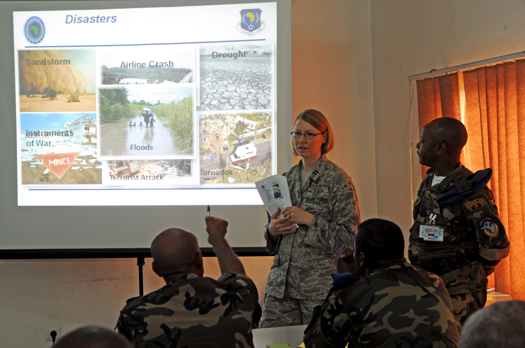 Capt. Danielle Butler briefs students on natural disasters March 24, 2014, in Angola, Africa. The intention of APF is to strengthen the regional partnerships within Africa by improving the proficiency and readiness of key mission areas through a collaborative learning environment. Butler is a  U.S. Air Forces in Europe and Air forces Africa surgeon general specialist. (U.S. Air Force photo/Capt. Sybil Taunton)
