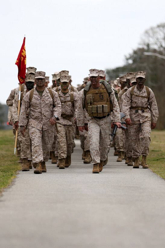 Lieutenant Col. Jaime L. Gutierrez, left, and Sgt. Maj. Jeffrey V. Dagenhart, right, lead a formation of students and instructors with Marine Corps Air Station Cherry Point's Center for Naval Aviation Technical Training during a six-mile hike at Cherry Point March 28, 2014. The Cherry Point CNATT Marines and Sailors took to the field as part of the school's implementation of the commandant and sergeant major of the Marine Corps' Reawakening campaign. The noncommissioned officer planned and led event included a six-mile hike, presentations from Marines with Cherry Point's 2nd Low Altitude Air Defense Battalion, a field meet and a field mess night. Gutierrez is CNATT's commanding officer and Dagenhart is the school's sergeant major.