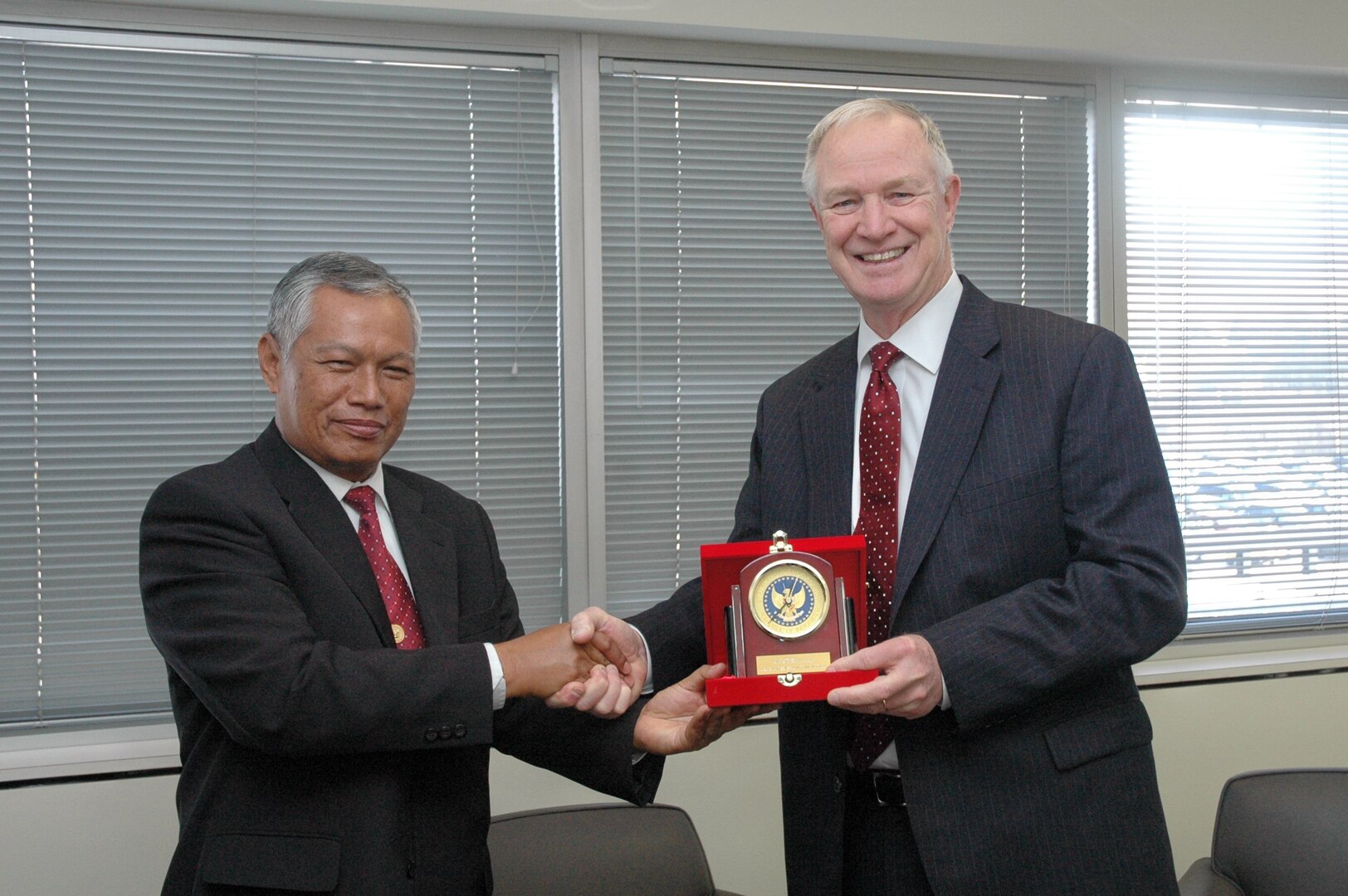 Special Advisor to Indonesia’s Chief of State Intelligence Agency presents Dr. David Ellison, president of the National Intelligence University, a gift from his agency