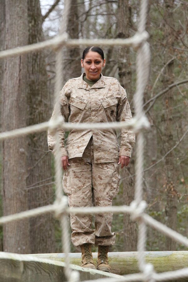 Gunny Sgt. Desiree Mercado, academic instructor, looks at an obstacle on the Tarzan Course, a mid-air ropes course, at the Officer Candidates School aboard Marine Corps Base Quantico on March 28, 2014. The challenge was part of an eight-station training event that Headquarters and Service Co. Marines participated in. 