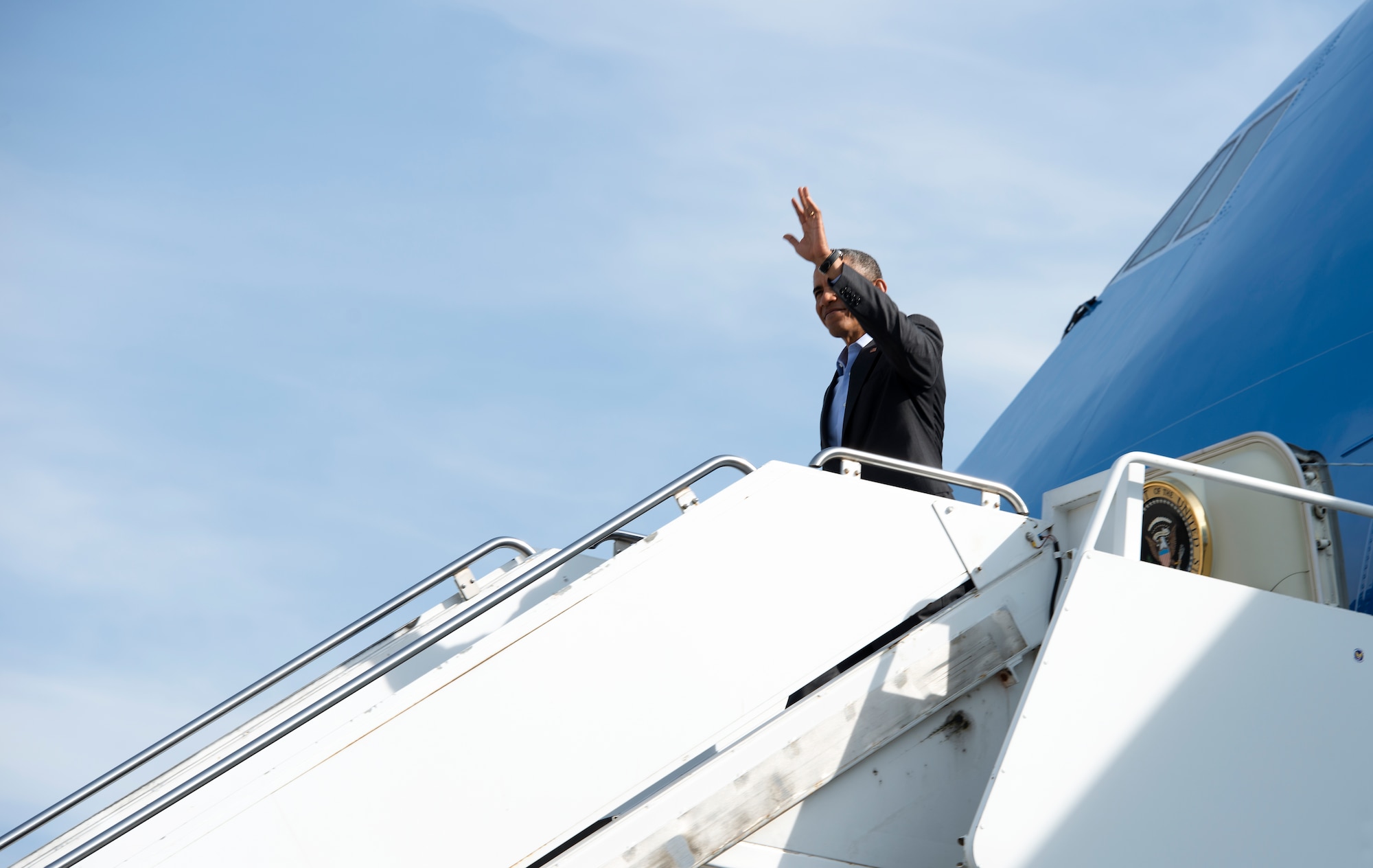 President Barack Obama waves hello as he exits Air Force One, March 29, 2014, at Ramstein Air Base, Germany. During his stop, Obama visited wounded warriors from Landstuhl Regional Medical Center. (U.S. Air Force photo/Senior Airman Damon Kasberg)