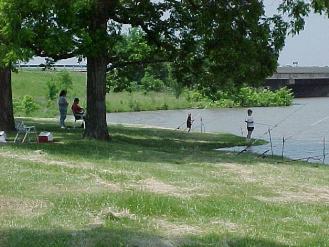 A family enjoys a day of fishing at Spaniard Creek recreation area at Webbers Falls.
