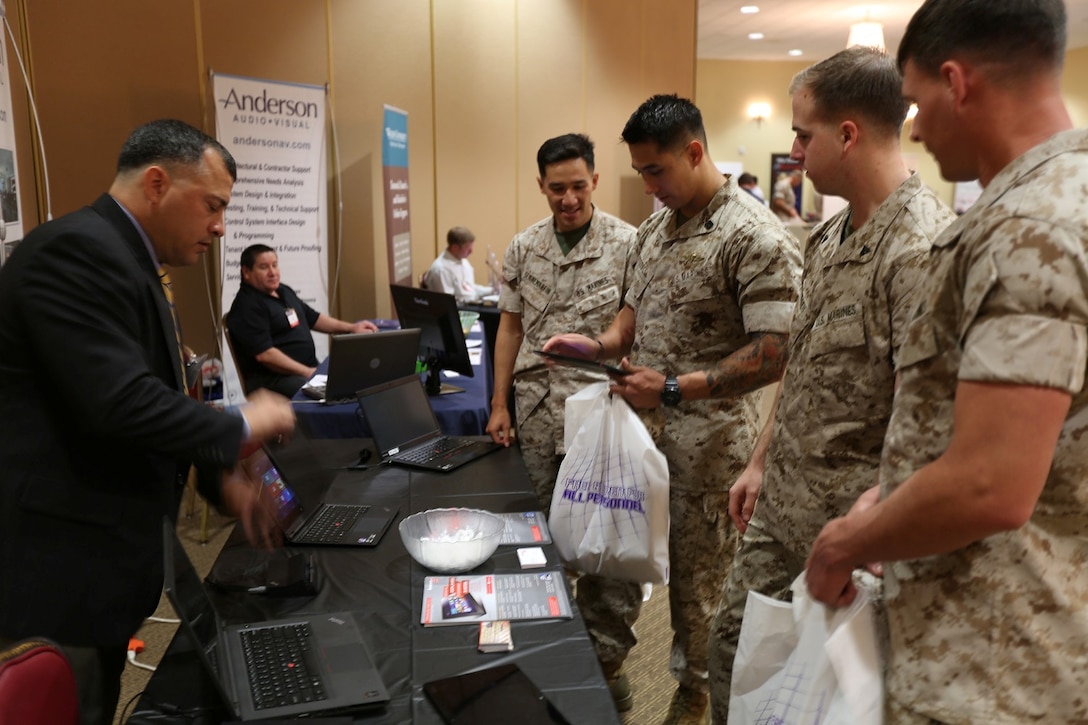 A representative of Lenovo, a computer technology company, demonstrates his products for Marines from the I Marine Expeditionary Force at the technology expo aboard Camp Pendleton, Calif., March 26. The I MEF Technology Expo allows units to view the latest in emerging technologies, network with industry experts, and share ideas and future goals.