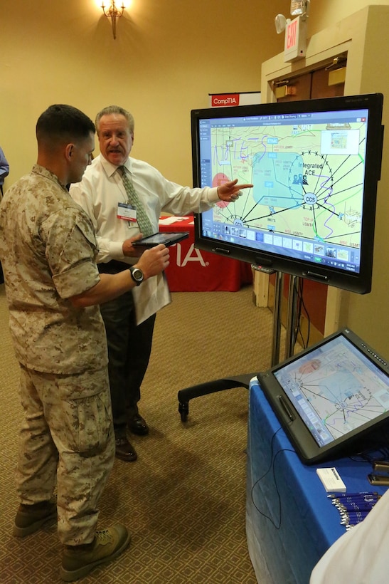 A representative of CompView, an audio visual design and integration technology company, demonstrates his products for Marines at the I Marine Expeditionary Force Technology Expo aboard Camp Pendleton, Calif., March 26. The expo allows units to view the latest in emerging technologies, network with industry experts, and share ideas and future goals.