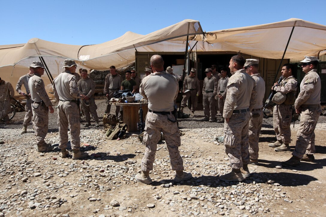 Marines with 4th platoon, Mobility Assault Company, 1st Combat Engineer Battalion, listen to a debrief of their route clearance mission through Helmand province, Afghanistan, March 24, 2014. Route clearance missions are conducted in frequently traveled areas around Camp Leatherneck, ridding it of any explosive hazards along the way and allowing for better freedom of movement for coalition forces and the civilian population along the route. (USMC Photo By: Sgt. Frances Johnson/Released)
