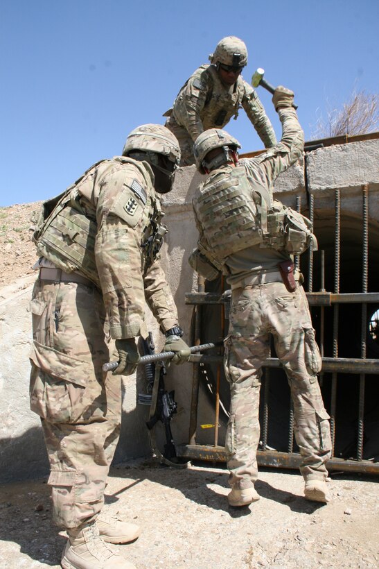 U.S. Army soldiers with the 65th Engineer Battalion install culvert denial systems along Highway 1 in Helmand province, Afghanistan, March 24, 2014 The system is comprised of two metal-bar grates that are placed at either ends of the culvert and held together by tension force cables, with an anti-tampering device secured to the grates. The device can detect any type of disturbance from vibrations to heat and will initiate a camera to record any tampering with the system.