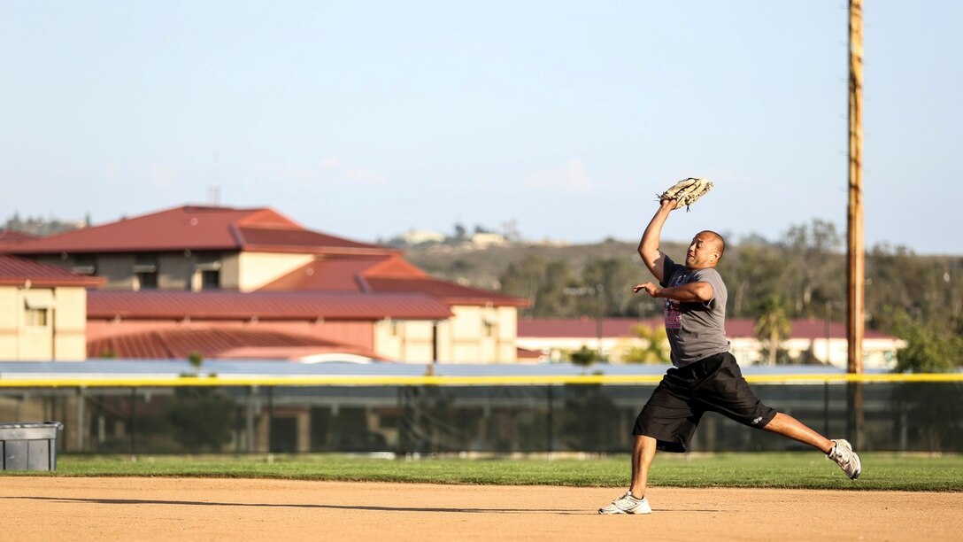Petty Officer 2nd Class Gabriel Cisneros, religious program specialist, 15th Marine Expeditionary Unit, makes a play at second base during a softball practice aboard Camp Pendleton, Calif., March 13, 2014. Cisneros, 36, is from Diamond Bar, Calif.  (U.S. Marine Corps video by Cpl. Emmanuel Ramos/Released)