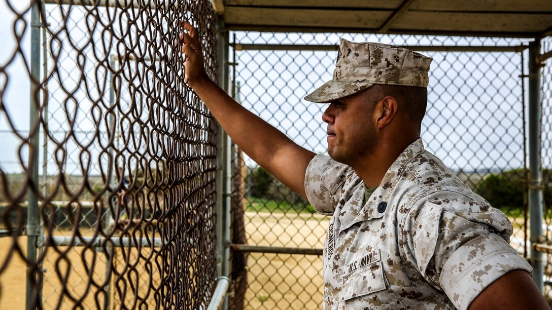 Petty Officer 2nd Class Gabriel Cisneros, religious program specialist, 15th Marine Expeditionary Unit, observes his softball team practice aboard Camp Pendleton, Calif., March 24, 2014. Cisneros, 36, is from Diamond Bar, Calif.  (U.S. Marine Corps video by Cpl. Emmanuel Ramos/Released)