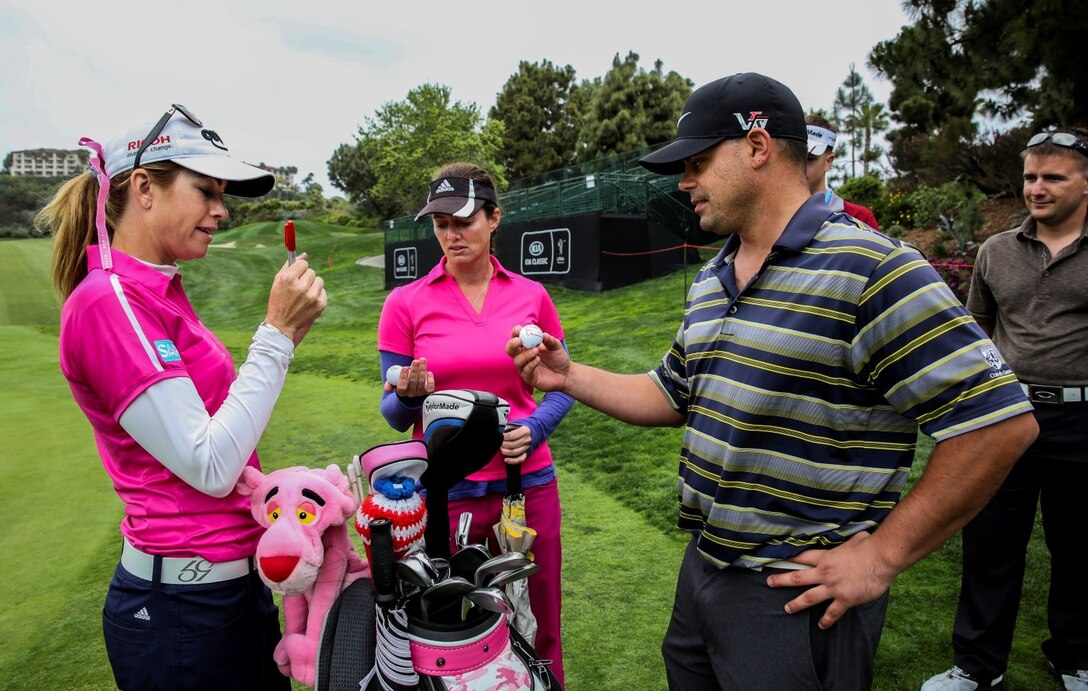 Paula Creamer, left, Ladies Professional Golf Association player, gives autographs to Marines with the 15th Marine Expeditionary Unit after a practice round at the Aviara Golf Club in Carlsbad, Calif., March 25, 2014. Creamer was raised in a military family and is dedicated to giving back to service members. (U.S. Marine Corps photo by Cpl. Emmanuel Ramos/Released)