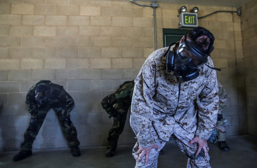 Staff Sgt. Leonard Kesselman, chemical, biological, radiological and nuclear defense noncommissioned officer, 15th Marine Expeditionary Unit, leads Marines in exercises during CBRN defense mask confidence training aboard Camp Pendleton, Calif., March 28, 2014. (U.S. Marine Corps photo by Cpl. Emmanuel Ramos/Released)