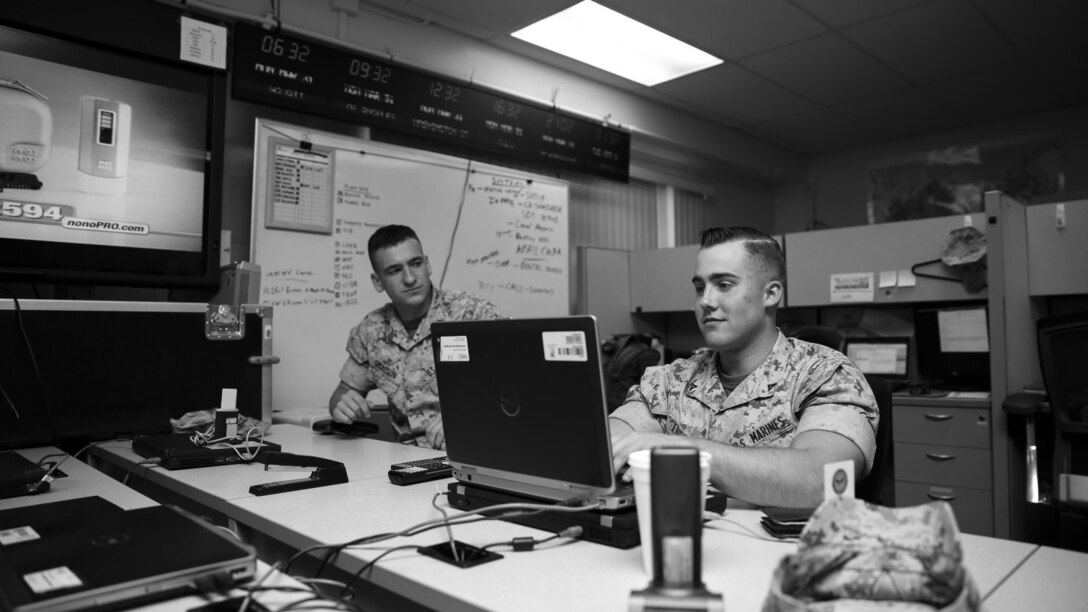 Lance Cpl. Austin Enders, right, intelligence specialist, 15th Marine Expeditionary Unit, reads current events as part of his morning routine aboard Camp Pendleton, Calif., March 27, 2014. Enders, 19, is from Halifax, Pa. and enlisted in the Marine Corps on Sept. 11, 2012 (U.S. Marine Corps photo by Cpl. Emmanuel Ramos/Released)