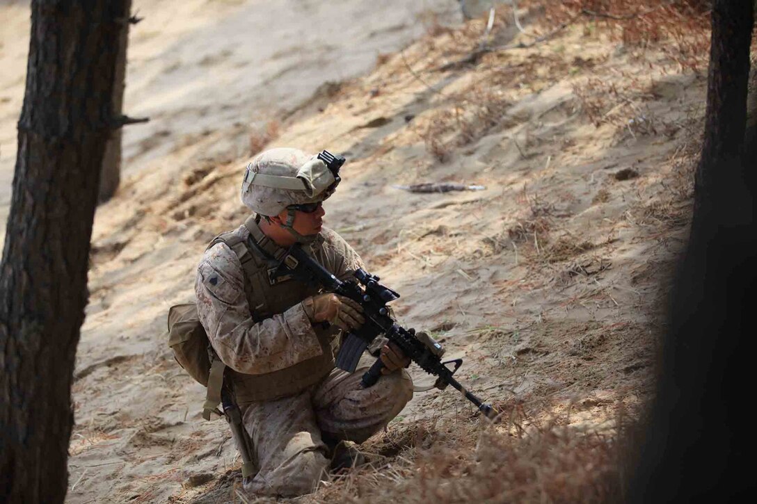 Sgt. Edwin T. Eslava, a squad leader with Bravo Company, Battalion Landing Team 1/4, 13th Marine Expeditionary Unit and Glendale, Calif., native, scans the terrain, during an amphibious training raid in Pohang, South Korea during Exercise Ssang Yong 14, March 31, 2014. Exercise Ssang Yong is conducted annually in the Republic of Korea (ROK) to enhance the interoperability of U.S. and ROK forces by performing a full spectrum of amphibious operations while showcasing sea-based power projection in   the Pacific. (Official U.S. Marine Corps photo by Sgt. Christopher O’Quin/Released)