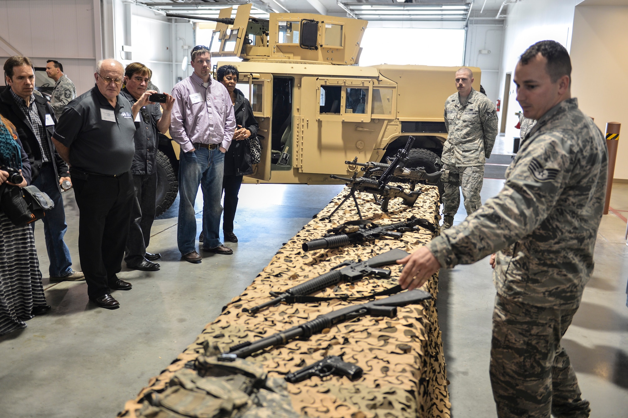 Staff Sgt. Dustin Current from the 621st Contingency Response Wing armory, briefs Joint Base Lewis-McChord, Wash., civic leaders about the weapons Airmen deploy with during a demonstration at Travis Air Force Base, Calif., March 28, 2014. Travis' 621st CRW was just one on many stops during the tour. (U.S. Air Force photo by Staff Sgt. Russ Jackson)