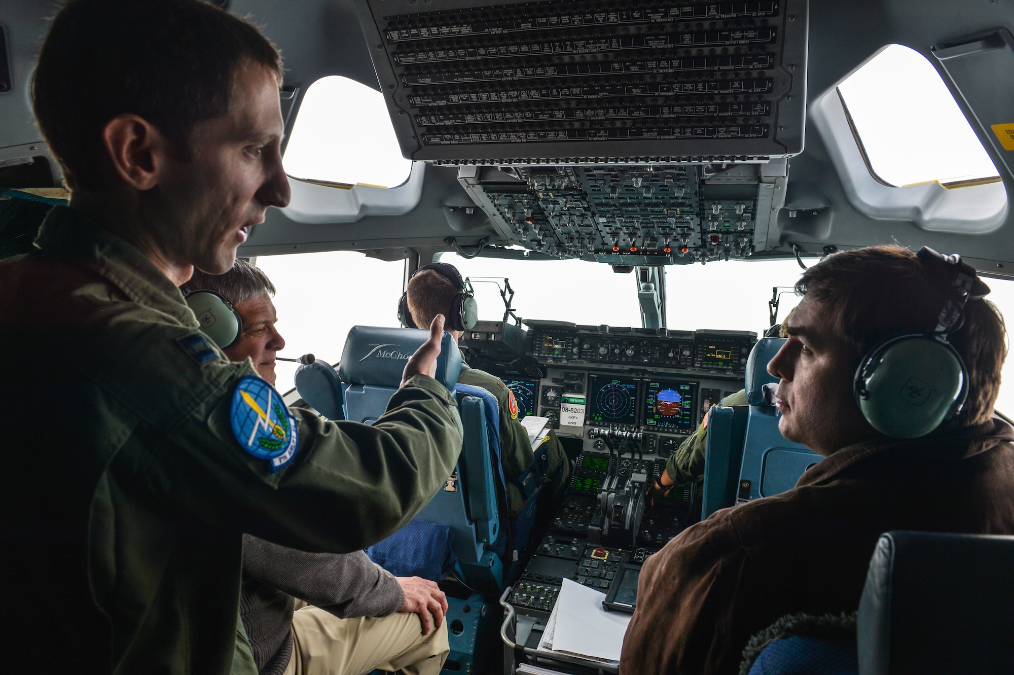 Capt. Mike Lewis, 62nd Airlift Wing executive officer, explains the air refueling process to Mayor Don Anderson of Lakewood, Wash., and Councilmember Jason Hearn of Lacey, Wash., onboard a C-17 Globemaster III March 28, 2014. Anderson and Hearn were part of the Fly-Away Civic Leader Tour that flew from Joint Base Lewis-McChord, Wash., to Travis Air Force Base, Calif. (U.S. Air Force photo by Staff Sgt. Russ Jackson)