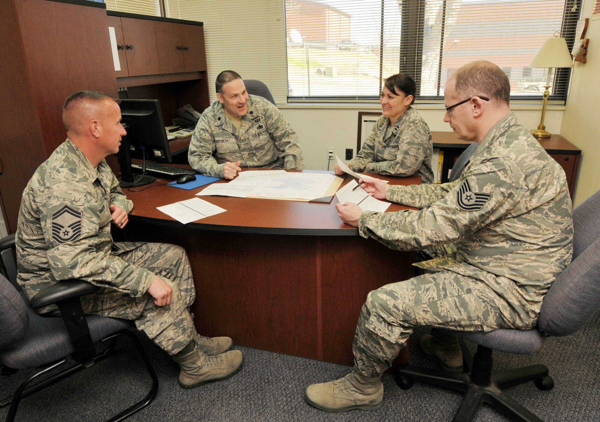 U.S. Air Force Senior Master Sgt. Christopher Amburn, 145th Base Contracting Officer, looks over Innovative Readiness Training financial reports with Commander, Lt. Col. Gregory Goforth, Capt. Jeanie Helms and Tech. Sgt. Joel Greene, 145th Comptroller Flight at the North Carolina Air National Guard base, Charlotte Douglas Intl. airport, March 10, 2014. IRT is a Department of Defense program that provides U.S. military professionals’ invaluable training as well as provides support to underserved communities. In the past year, 145th CF, working with SMSgt Amburn has managed over $2.6 Million DoD funds for ANG, Air Force Reserve, Marines, Navy, and ARMY IRT missions. (U.S. Air National Guard photo by Master Sgt. Patricia F. Moran, 145th Public Affairs/Released)