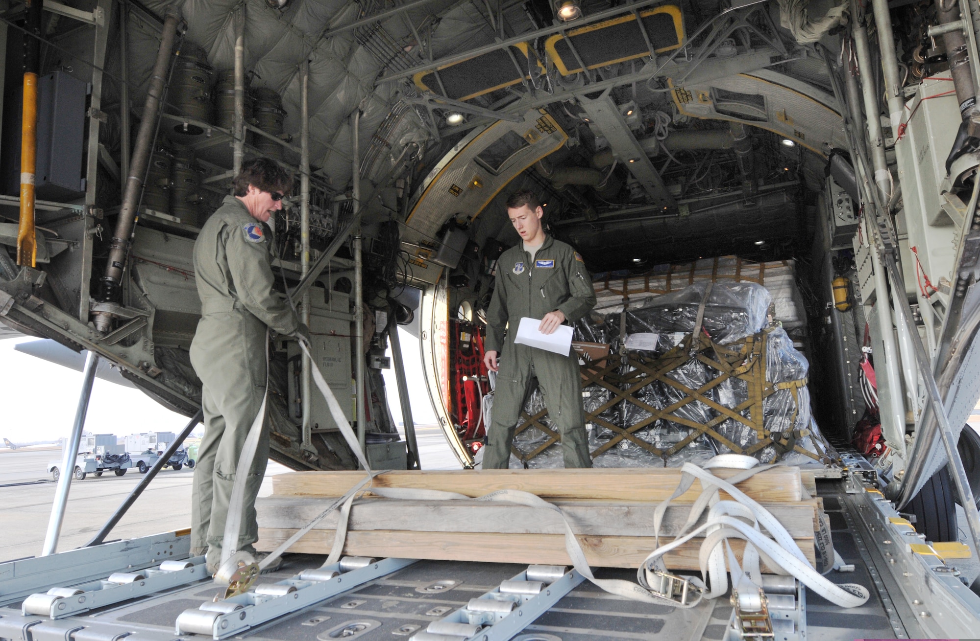 U.S. Air Force Master Sgt. Pennie Brawley and Senior Airman Phillip Mallette, loadmasters from the 156th Airlift Squadron, secure pallets containing medical and dental supplies onboard a 145th Airlift Wing, C-130 Hercules aircraft at the North Carolina Air National Guard base, Charlotte Douglas Intl. airport, February 20, 2014. NCANG airmen prepare to fly to Louisiana in support of Cajun Care 2014, a Department of Defense, Innovative Readiness Training mission designed to provide U.S. military medical professionals invaluable training as well as provide health care options to a medically underserved community. (U.S. Air National Guard photo by Master Sgt. Patricia F. Moran, 145th Public Affairs/Released)