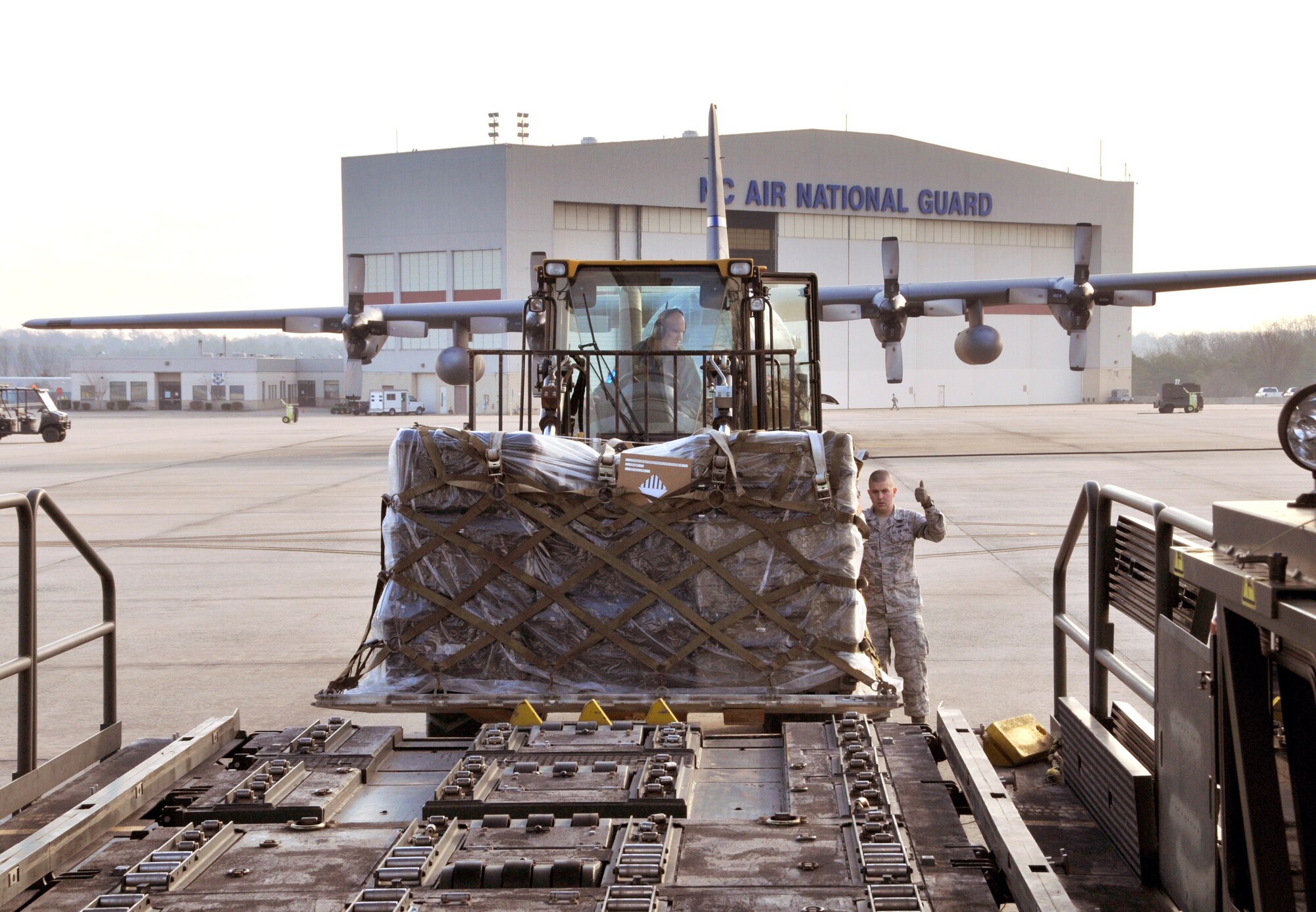 U.S. Air Force Tech. Sgt. Phillip Harrell and Staff Sgt. Jesse Huneycutt, 145th Logistics Readiness Squadron, Air Transportation Specialists, use a K-Loader and 10k All Terrain forklift to load pallets containing dental and medical supplies onto a C-130 Hercules aircraft at the North Carolina Air National Guard base, Charlotte Douglas Intl. airport, February 20, 2014. The 145th Airlift Wing prepares a flight bound for Louisiana in support of Cajun Care 2014, a Department of Defense, Innovative Readiness Training mission designed to provide U.S. military medical professionals invaluable training as well as provide health care options to a medically underserved community. (U.S. Air National Guard photo by Master Sgt. Patricia F. Moran, 145th Public Affairs/Released)