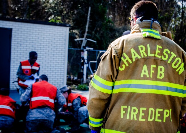 David Hawkins, 628th Civil Engineering Squadron fire fighter, looks on as first responders from Joint Base Charleston take part in a Mass Casualty Exercise March 28, 2014, at JB Charleston – Air Base, S.C. The purpose of the exercise was to test the ability of JB Charleston first responders in the event of an emergency. (U.S. Air Force photo / Senior Airman Tom Brading)