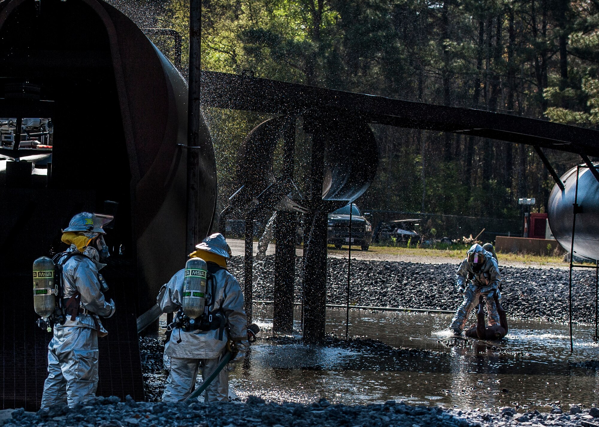Tech Sgt. Jeffrey Kronenberger , Marcus Shephard and Staff Sgt. Damien Montero, 628th Civil Engineering Squadron fire fighters, take part in a Mass Casualty Exercise March 28, 2014, at JB Charleston – Air Base, S.C.  The purpose of the exercise was to test the ability of JB Charleston first responders in the event of an emergency. (U.S. Air Force photo / Senior Airman Tom Brading)