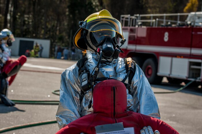 Airman 1st Class Melvin McCormick, 628th Civil Engineering Squadron fire fighter, brings a simulated victim to safety during a Mass Casualty Exercise March 28, 2014, at JB Charleston – Air Base, S.C.  The purpose of the exercise was to test the ability of JB Charleston first responders in the event of an emergency. (U.S. Air Force photo / Senior Airman Tom Brading)