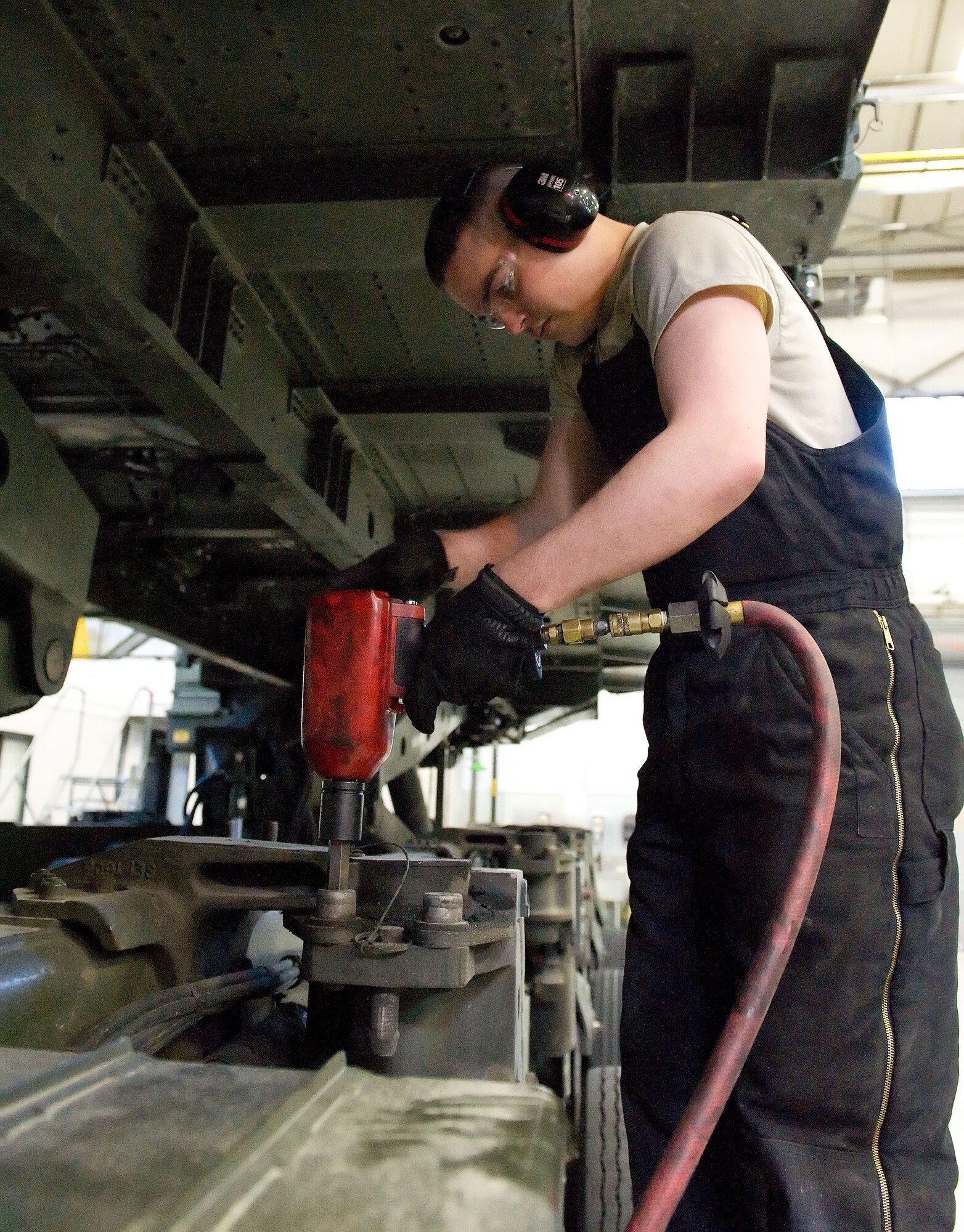 Airman 1st Class Jacob Parks, 436th Logistics Readiness Squadron material handling equipment maintenance apprentice, removes a Tunner 60K aircraft cargo loader/transporter bogie assembly bolt April 1, 2014, at the MHE maintenance section on Dover Air Force Base, Del. Each bogie assembly has six bolts that secure it to the frame of the cargo loader. (U.S. Air Force photo/Roland Balik)
