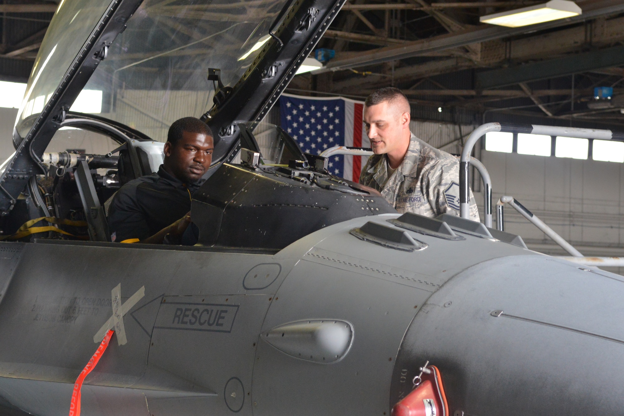 Lawrence Timmons, Pittsburgh Steelers #94 (left), visited Shaw Air Force Base, S.C., March 28, 2014, Timmons toured the base, meeting Airmen and getting to know the mission of the 20th Fighter Wing. He conducted an autograph signing and received the commander's coin from U.S. Air Force Col. Clay Hall, 20th Fighter Wing commander. (U.S. Air Force photo by Senior Airman Ashley Gardner/Released)