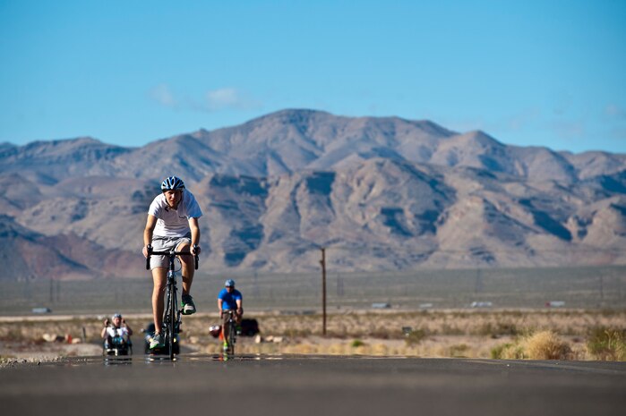 Cody Caraker, adaptive sports camp participant, cycles through Nellis Air Force Base, Nev. Area 2 during an Air Force Wounded Warrior Adaptive Sports Camp Feb. 26, 2014.  The 2014 Warrior Games Selection Camp will begin April 7 with 100 athletes coming from across the United States to compete for the 40 positions on the U.S. Air Force team.  (U.S. Air Force photo by Senior Airman Christopher Tam)