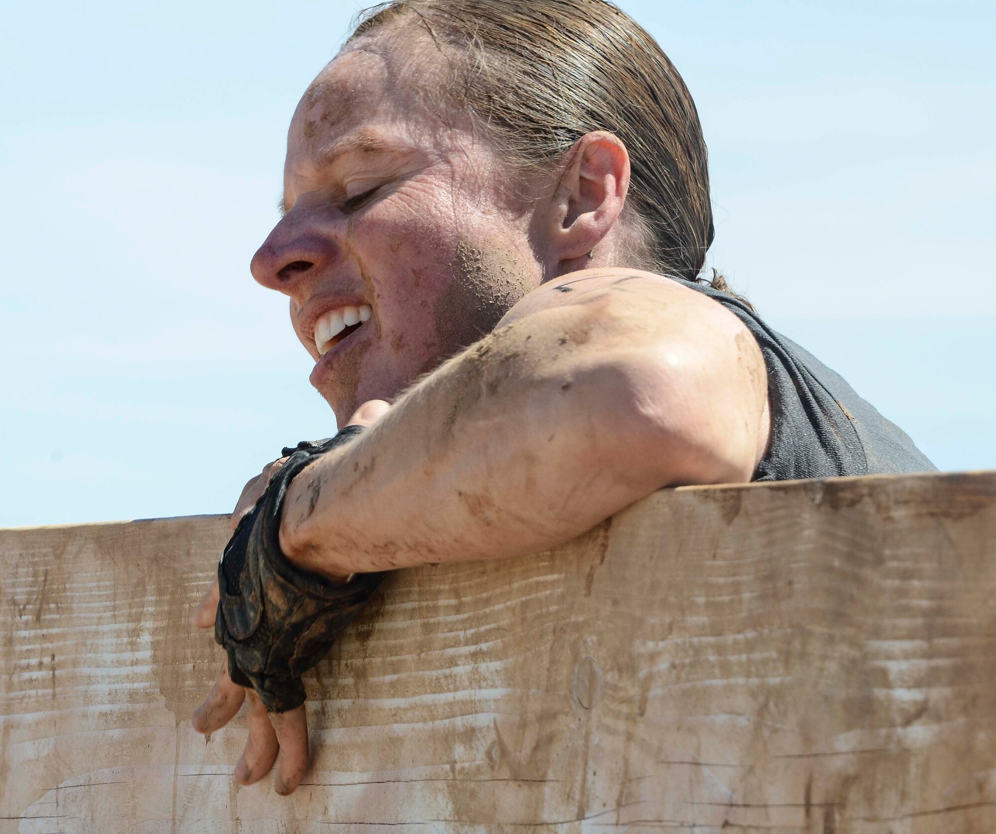 Capt. Yvonne Nollmann, 12th Air Force (Air Forces Southern) Section Commander, attempts to crawl over a wall during the Hard Charge Televised Obstacle Mission at the Pima County Fairgrounds in Tucson, Ariz., on March 29. Climbing, crawling and sprinting were a few of the many ways the members form 12th AF passed though the rigorous four-mile 37-obstacle course. (U.S. Air Force photo by Staff Sgt. Adam Grant/Released)