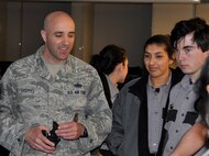Tech. Sgt. Aaron Thomas shows some of security forces tools of the trade to Pueblo County Sheriff’s Office Explorer Post #157 cadets. The program is intended to give young adults of Pueblo County an opportunity to observe and interact with different aspects of law enforcement. These “Posts” are designed to help the cadets become better citizens and community members. They also give law enforcement members the chance to interact with the community and young adults. Thomas, an Active Guard Reservist, is the noncommissioned officer in charge of training with the 302nd Security Forces Squadron. (U.S. Air Force photo/Master Sgt. Daniel Butterfield)