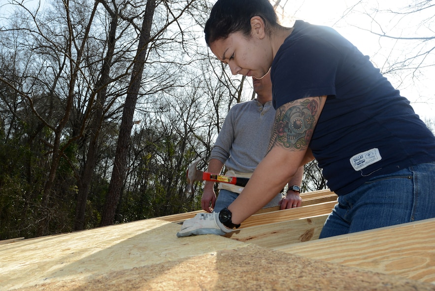 U.S. Air Force Airman 1st Class Josefina Hernandez, 20th Force Support Squadron Military Personnel Flight reenlistment and extensions journeyman, hammers a board to a rafter March 22, 2014, in Camden S.C. Hernandez and 10 other 20th FSS Airmen volunteered with Kershaw County Habitat for Humanity to work on construction of a four-bedroom home as part of a volunteer partnership with the organization. (U.S. Air Force photo by Senior Airman Laura L. Valentine/Released) 