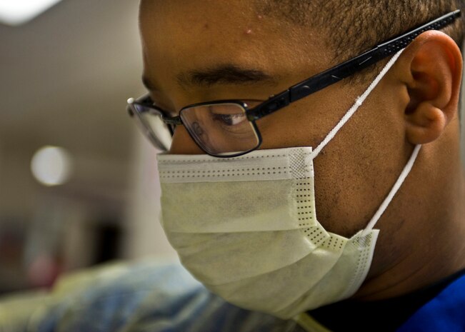 U.S. Air Force Tech. Sgt. Chuck Broadus, 99th Medical Operations Squadron NCO in charge of the Emergency Room, prepares to enter a burn victim’s room March 28, 2014, at University Medical Center, Las Vegas. UMC is the state-designated level I trauma center for Southern Nevada. (U.S. Air Force photo by Airman 1st Class Jason Couillard)