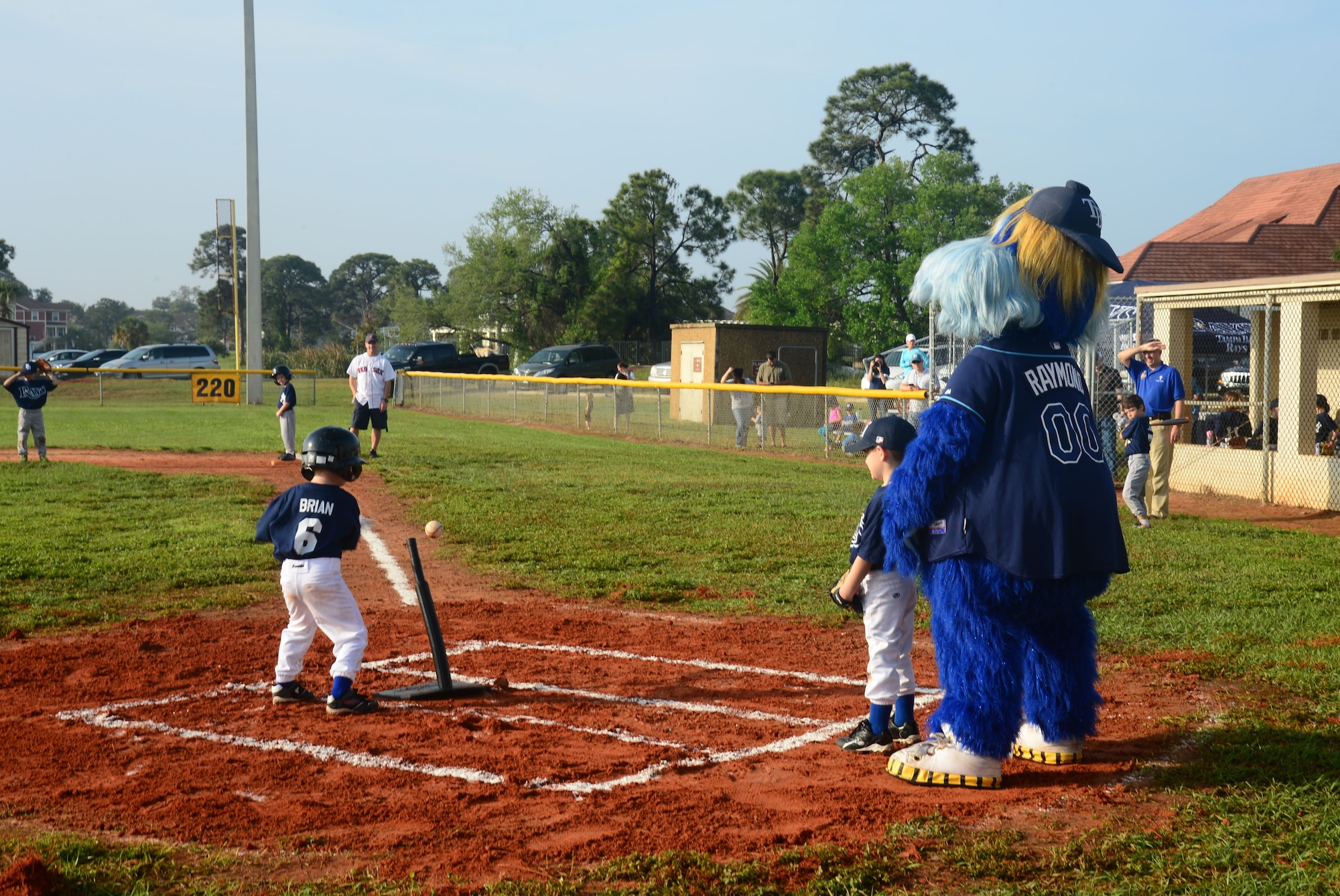Youth baseball teams take the field during the youth baseball opening ceremony and games at MacDill Air Force Base, Fla., March 29, 2014. Raymond, Tampa Bay Rays mascot, came out to cheer on the kids during their games. (U.S. Air Force photo by Airman 1st Class Tori Schultz/Released)
