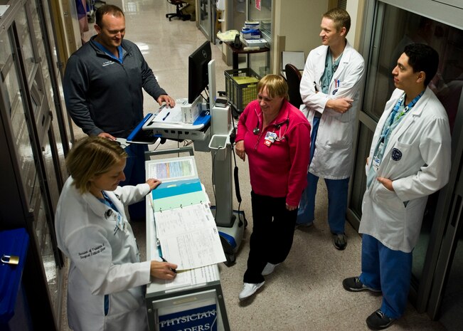 U.S. Air Force Maj. (Dr.) Nichole Ingalls (bottom left), 99th Surgical Operations Squadron trauma surgeon, reviews medical records prior to conducting patient rounds March 3, 2014, at University Medical Center, Las Vegas. Patient rounds are a daily visit by the attending physician and a team of medical professionals to all of the physicians’ patients. Rounding by medical staff is an important part of on the job training and education to focus on immediate care for the patients. (U.S. Air Force photo by Senior Airman Jason Couillard)